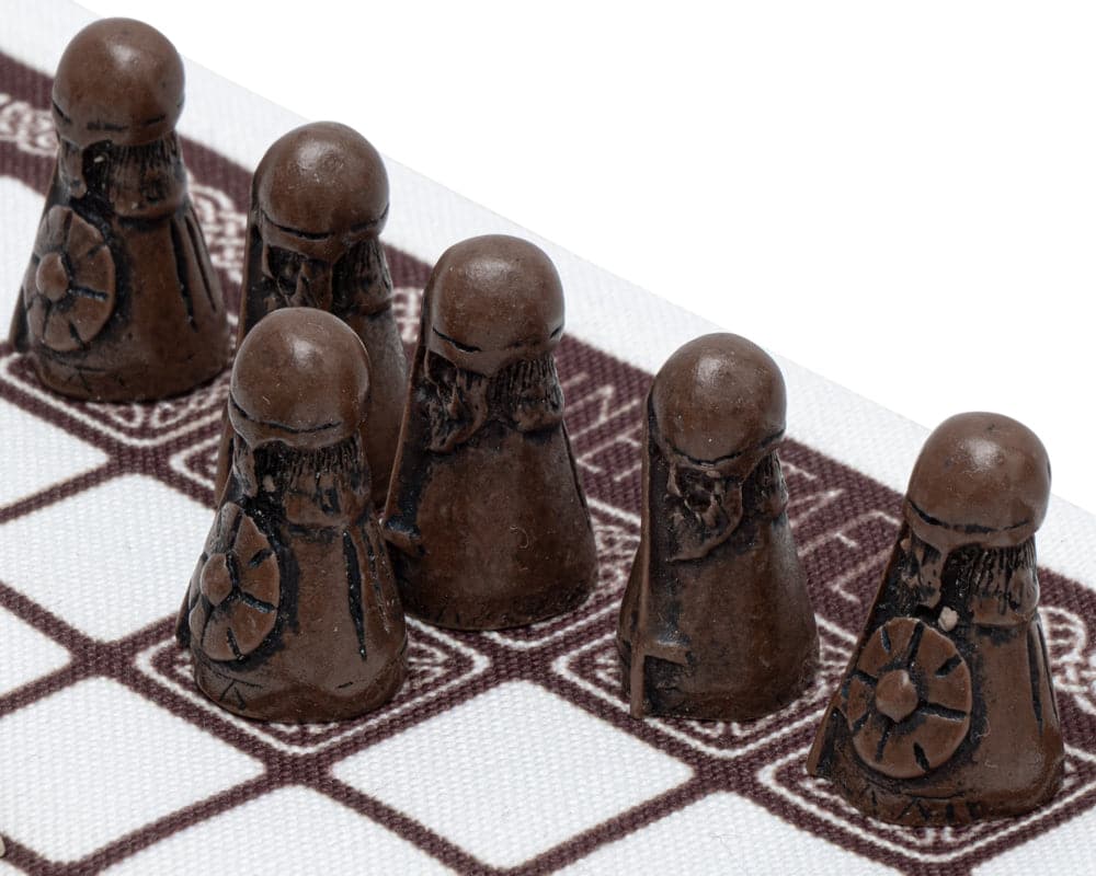 Dark attackers on linen playing surface of Hnefatafl - The Viking Game displayed in gift box presentation, made in the UK.