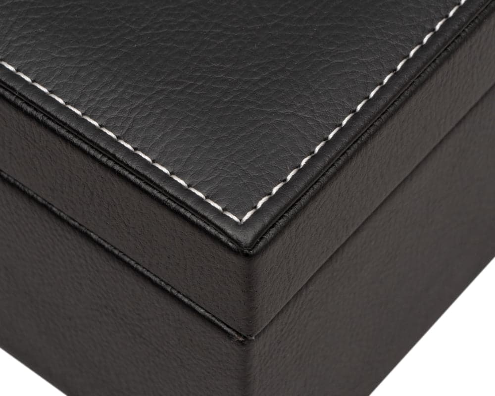 Close-up of black leatherette chess piece storage box with white stitching detail.