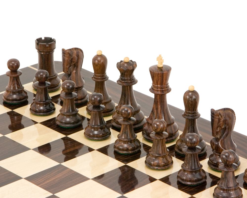 Antipodean Series Rosewood Staunton chessmen set up on a dark grain chessboard with a 4-inch king.