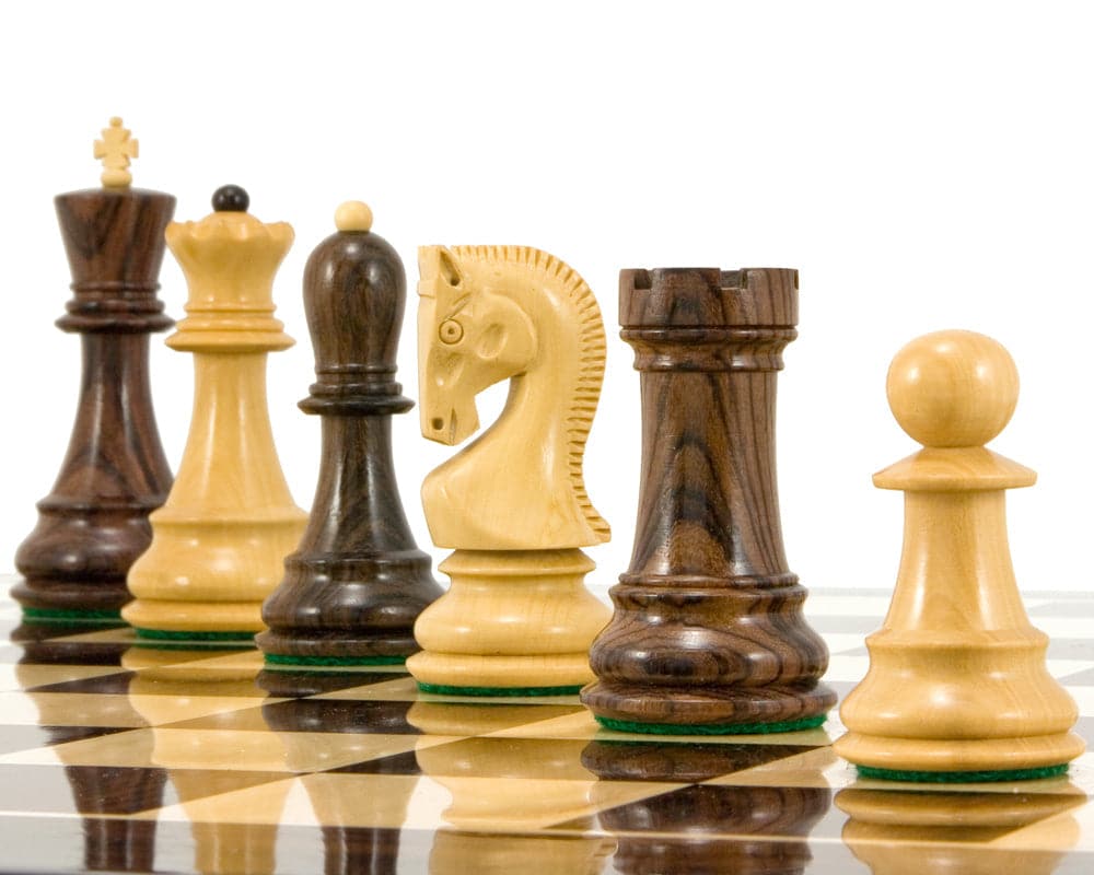 Antipodean Series Rosewood Staunton Chessmen arranged on a chessboard, featuring solid rosewood pieces with contrasting decor.