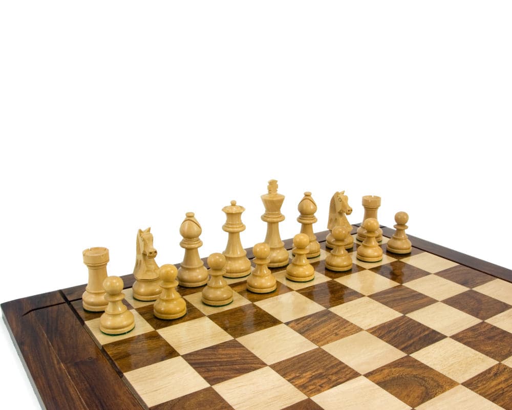 Ebonised Staunton chess pieces arranged on a 17 inch board.