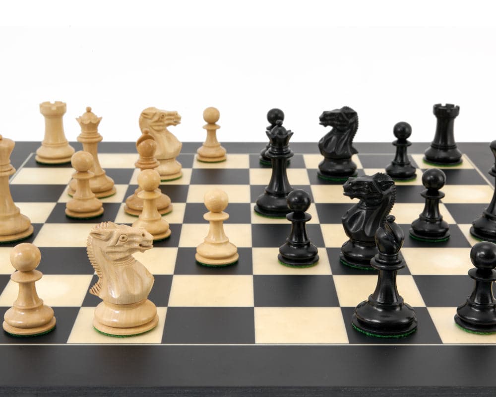 Highgrove Series Ebonised Staunton chess pieces displayed on a chessboard with classic Staunton design featuring detailed knights and bishops