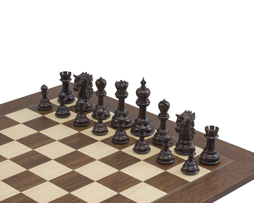 The Dubliner Rosewood Chess Men set on a wooden chessboard, featuring a 4.7 inch ornate King and additional Queens.