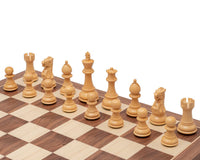 3.5 Inch Classic Staunton Chessmen in Acacia Wood on chess board, featuring a traditional design with a 3.5 inch king and two extra queens.