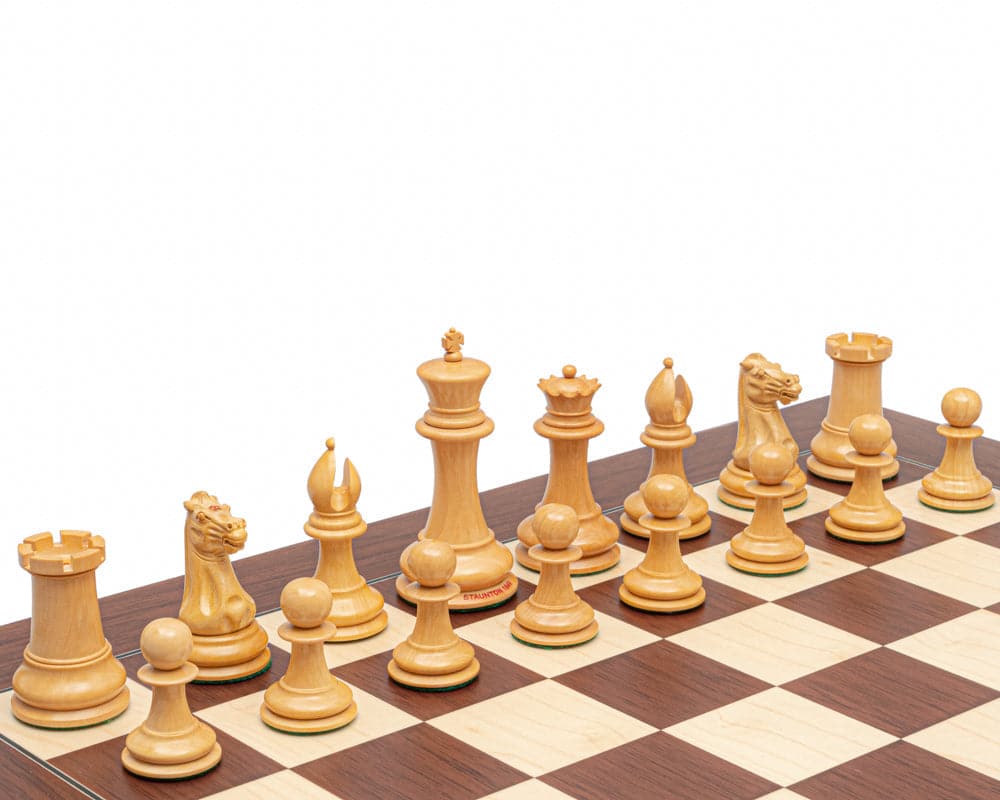 Staunton 1849 Reproduction Chessmen in boxwood on a chessboard, featuring a 4.4 inch king and finely detailed pieces.