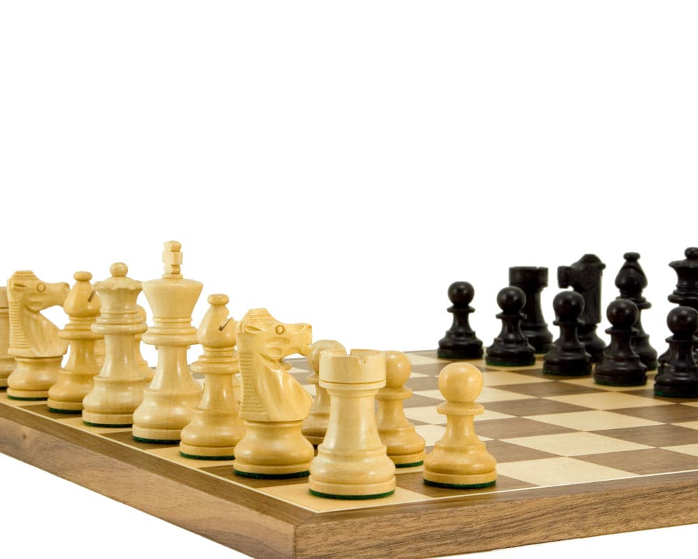 French Knight ebonised Staunton chess pieces on walnut board with oversize playing squares.