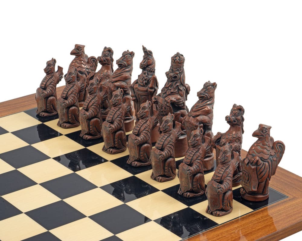 Royal Beasts Metal and Palisander chess set with intricately designed animal pieces on a wooden chessboard.