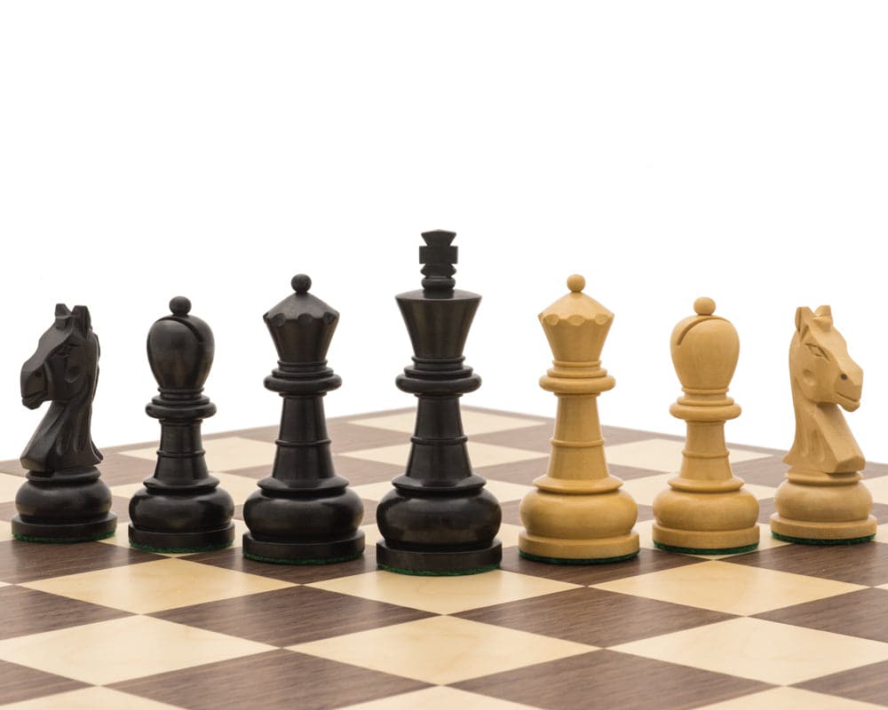 Black and walnut chess pieces on a chessboard from The Emerald Black and Walnut Folding Chess Set.