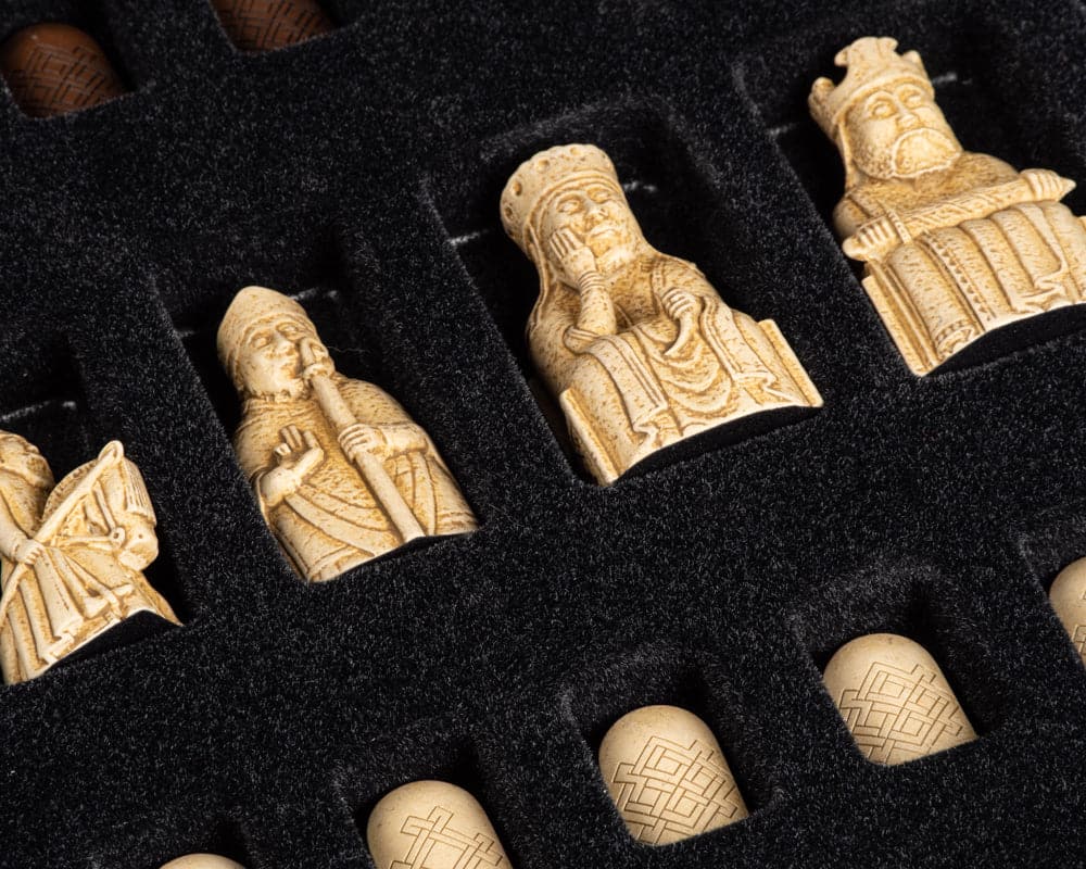 Close-up of Isle of Lewis chess pieces in presentation box for deluxe chess set in walnut.