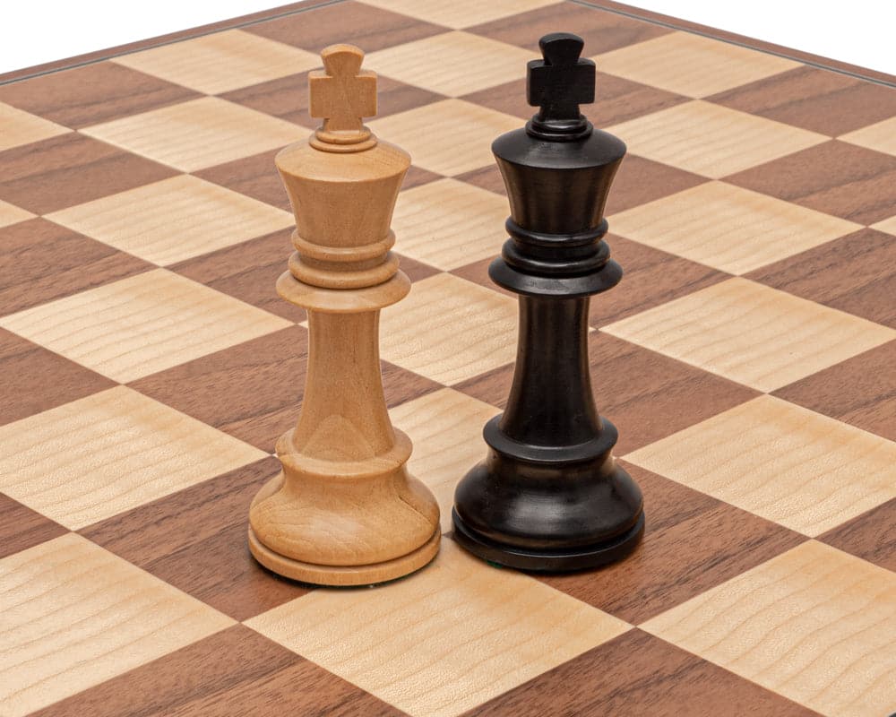 The Conquest Walnut and Black Folding Chess Set - Hand carved boxwood and ebonised 4-inch king chess pieces on walnut and maple board.