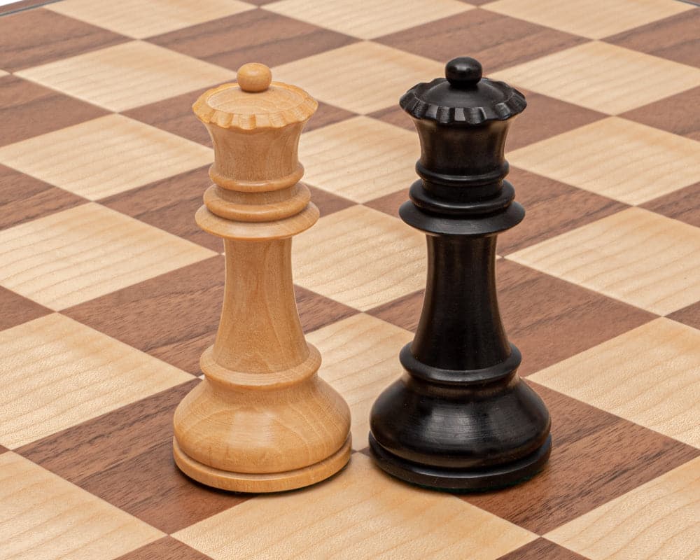 Hand-turned Staunton chess queens on walnut and maple chessboard from The Conquest Walnut and Black Folding Chess Set