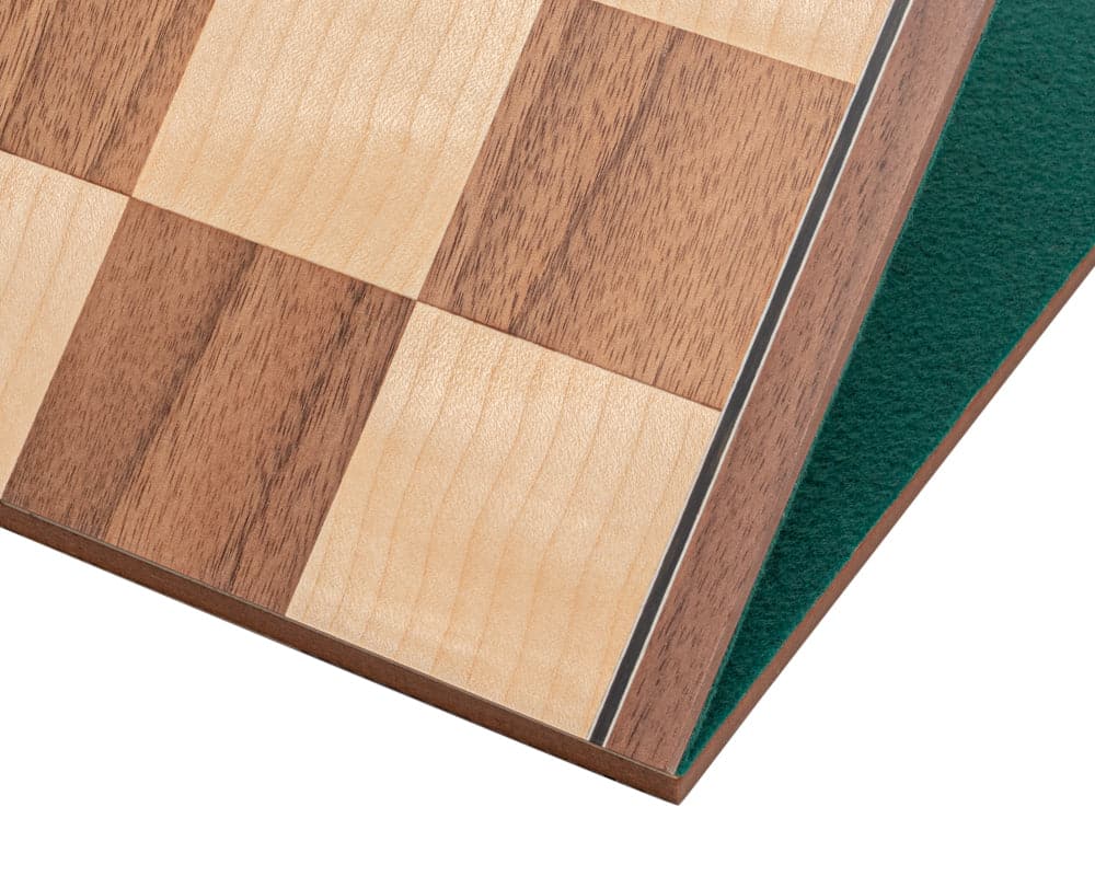 Close-up of The Conquest Walnut and Black Folding Chess Set board showing walnut and maple squares with green felted backing.