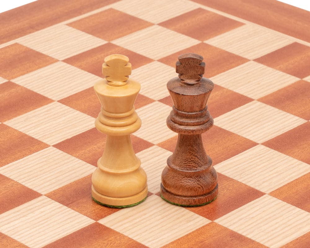 Two chess kings from the Down Head Sheesham and Mahogany Chess Set on a high quality 15.75 inch board with mahogany and birch veneers.