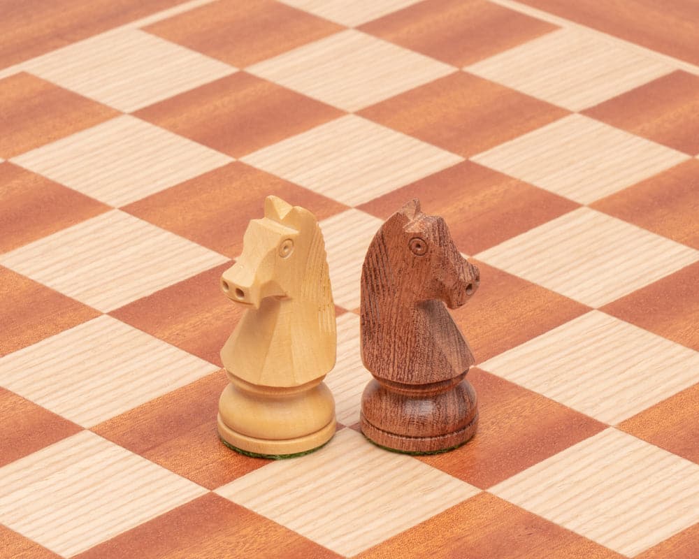 Sheesham and boxwood chess knights on a mahogany and birch chessboard from the Down Head Sheesham and Mahogany Chess Set