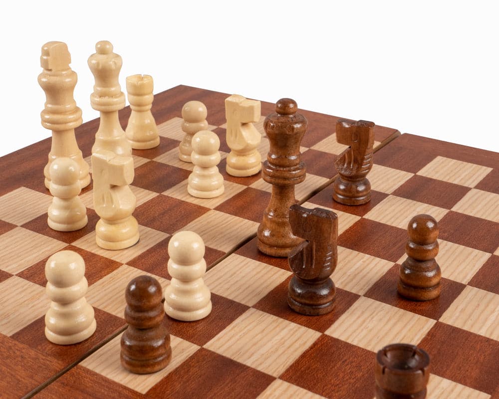 Chessboard with wooden chess pieces on a travel-sized mahogany backgammon and chess set