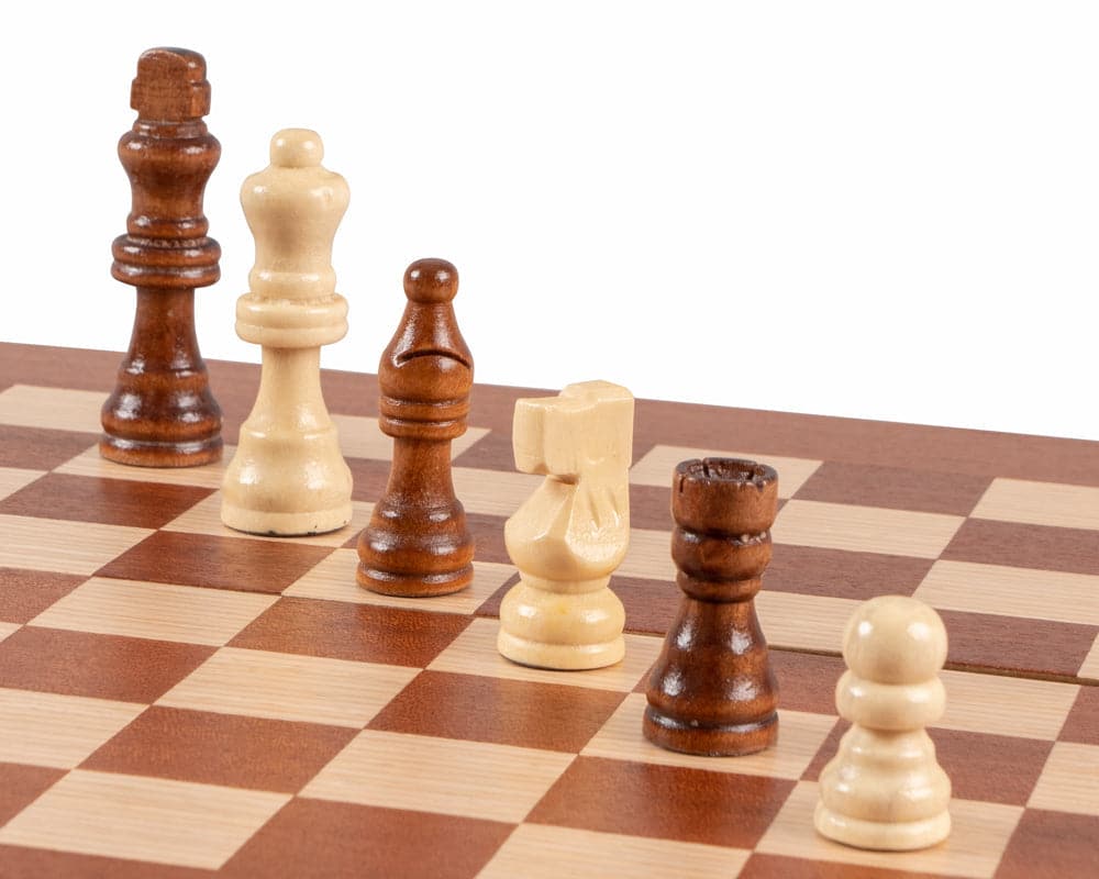 Close-up of chess pieces on a mahogany combination backgammon and chess board set, featuring deluxe Philos cups and travel-friendly design.