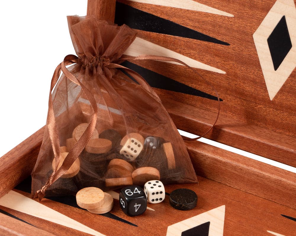 Chess and backgammon pieces in mesh bag on mahogany travel-sized combination game set