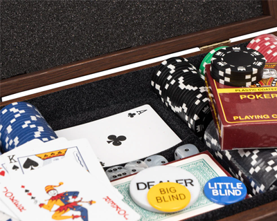 Poker set with chips, cards, and dealer buttons in a wooden box